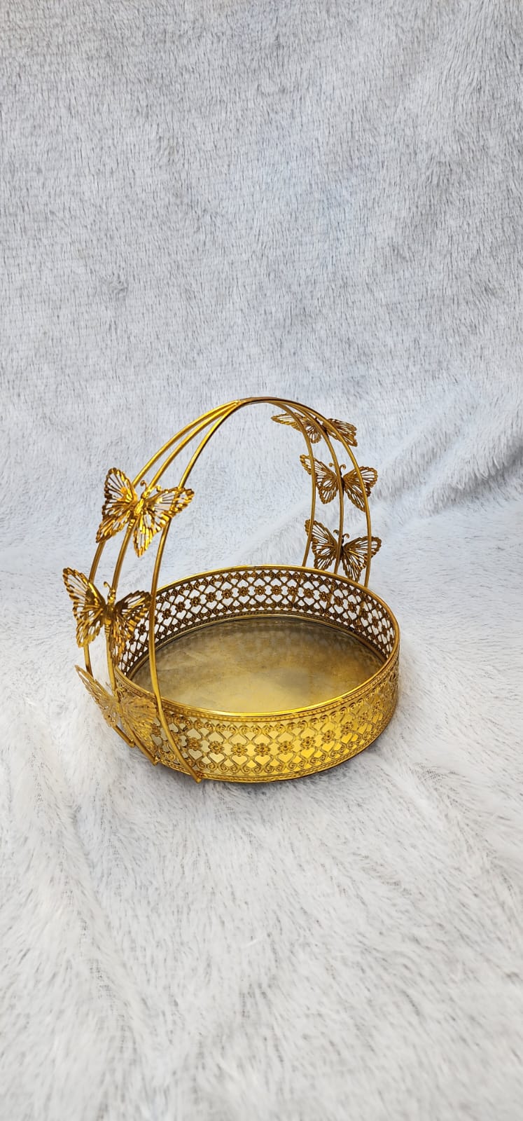 Golden metal gift hamper basket with a butterfly design.