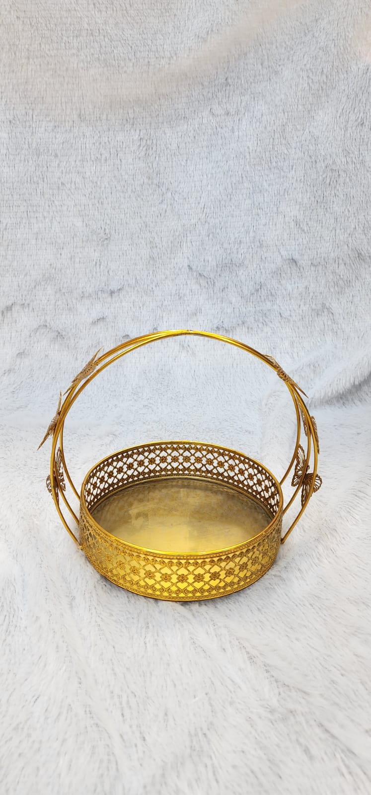 Golden metal gift hamper basket with a butterfly design.